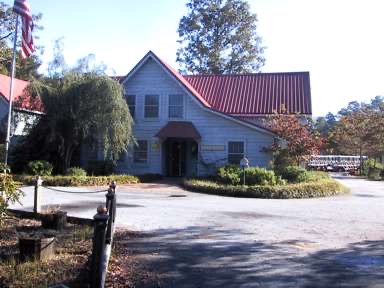 The Brickyard Plantation pro shop, housed in the property's original barn with its signature red metal roof.